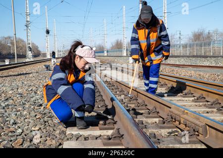 (230307) -- HARBIN, March 7, 2023 (Xinhua) -- Female inspectors work at the Dorbod Railway Station in Daqing, northeast China's Heilongjiang Province, March 6, 2023. At the Dorbod railway line maintenance section of China Railway Harbin Bureau Group Co., Ltd., there is a six-member team of female inspectors with an average age of 29. Their responsibilities include maintaining the railway lines for grain and oil transport, as well as 148 kilometers of Binzhou railway line, which is a crucial part of China-Europe rail transport service line. Despite facing challenging conditions, they tackle dai Stock Photo