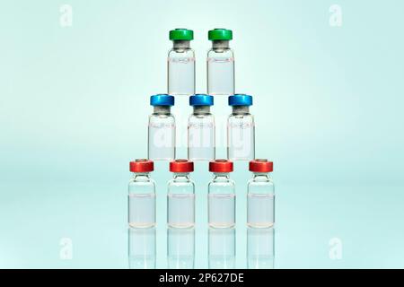 A collection of multi-purpose transparent bottles with colored caps, standing and arranged and on a blue background. pharmacology products Stock Photo