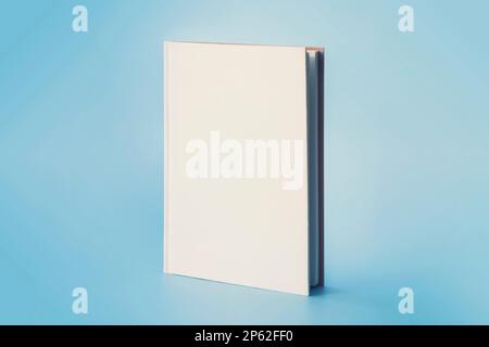 a white book on a blue background. Empty space on the cover for design and text Stock Photo