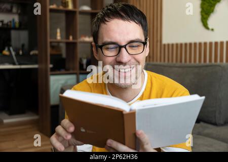 young man reading book at home in the room Stock Photo