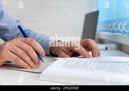 male hands close-up taking notes. the concept of working in an office or training Stock Photo