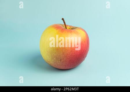 ripe red apple on blue background Stock Photo