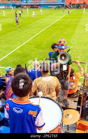 Supporter band playing instruments and banging drum at Thai football match, PAT Stadium, Bangkok, Thailand Stock Photo