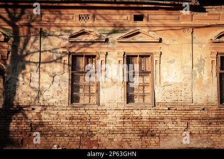 Picture of facades with boarded windows, ready for destruction and renovation and heavy reconstruction. Stock Photo