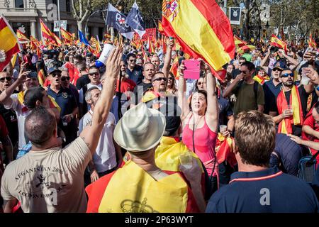Anti-independence Catalan protestors carry Spanish flags during a demonstration for the unity of Spain on the occasion of the Spanish National Day at Stock Photo