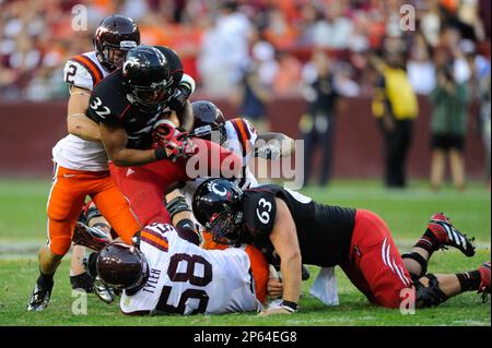 Virginia Tech running back George Bell (34) tries to stretch the ball  across the goal line as Virginia linebacker Clint Sintim (51) grabs the  ball during the Virginia-Virginia Tech college football game