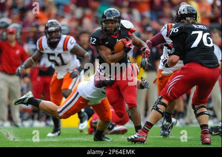 Virginia Tech running back George Bell (34) tries to stretch the ball  across the goal line as Virginia linebacker Clint Sintim (51) grabs the  ball during the Virginia-Virginia Tech college football game