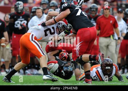 Virginia Tech running back George Bell (34) tries to stretch the ball  across the goal line as Virginia linebacker Clint Sintim (51) grabs the  ball during the Virginia-Virginia Tech college football game