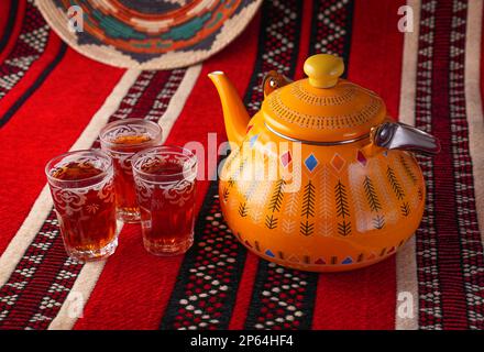 Iconic Arabian fabric is graced with symbols of Arabia, in particular Arabic tea and dates, they symbolise Arabian hospitality, ramadan set Traditiona Stock Photo