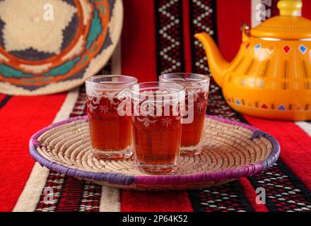 Iconic Arabian fabric is graced with symbols of Arabia, in particular Arabic tea and dates, they symbolise Arabian hospitality, ramadan set Traditiona Stock Photo