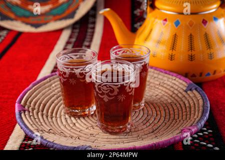 Iconic Arabian fabric is graced with symbols of Arabia, in particular Arabic tea and dates, they symbolise Arabian hospitality, ramadan set Traditiona Stock Photo