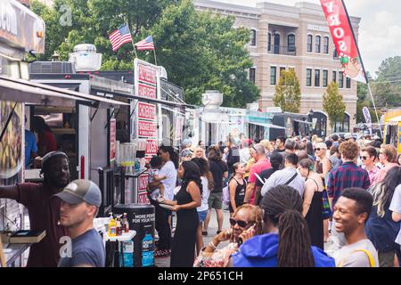 Suwanee, GA / USA - September 18, 2022:  A crowd of people wait in line at food trucks at Suwanee Fest, a fall festival on September 18, 2022. Stock Photo