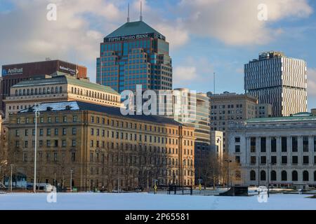 Cleveland, Ohio, USA - January 25, 2023:  Snow covers the ground in an area infront of buildings in downtown district. Stock Photo