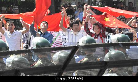 Chinese protesters wave their national flags in fornt of the Japanese Embassy in Beijing on Sept. 17, 2012. Angry anti-Japan demonstrators have marched and staged a rally across China since Japanese government purchased the Senkaku Islands, called Diaoyu in China in the East China Sea. ( The Yomiuri Shimbun via AP Images )