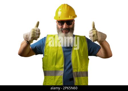 Man with white beard dressed in yellow helmet and reflective vest holding thumbs up Stock Photo