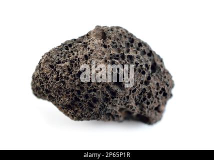 Porous black volcanic rock isolated on white background. Lava stone, pumice stone, or volcanic pumice with distinctive pores. Isolated on white backgr Stock Photo