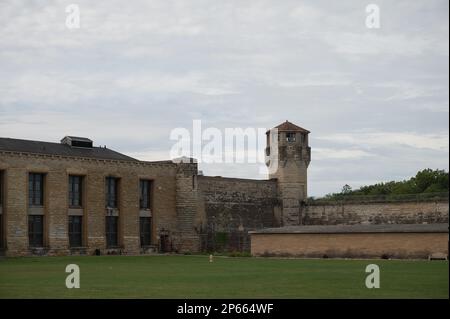 The facade of the historic Joliet Prison against a cloudy sky Stock Photo