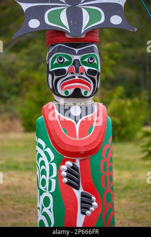 Kwakwaka'wakw totem poles in the cemetery in Alert Bay, Cormorant Island, British Columba, Canada, North America Stock Photo