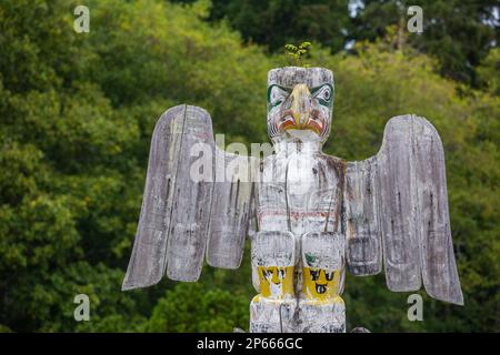 Kwakwaka'wakw totem poles in the cemetery in Alert Bay, Cormorant Island, British Columba, Canada, North America Stock Photo