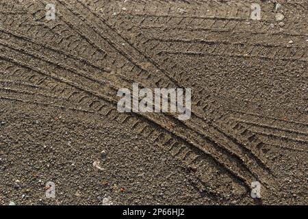 Deep tractor tire trail on a green grass in a field, Agriculture industry or work in a park concept. Stock Photo