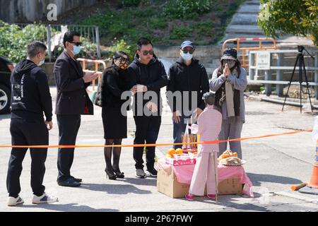 Chris Tam (3rd from right), partner of Abby Choi Tin-fung, with Choi's mother (3rd from left), her father (2nd from left) and Chris' parent, mourns the socialite at the crime scene in Lung Mei Village, Tai Po. A headless body, which was believed to be Choi, was found. Police suspect she was murdered and dismembered by the family of her ex-husband. 28FEB23    SCMP / Elson Li Stock Photo