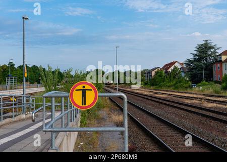 Prohibition sign No trespassing on the railway platform. Railroad tracks going into the distance. Stock Photo