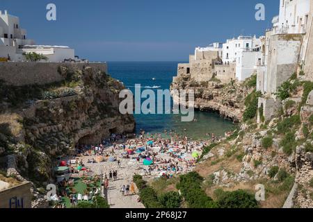 View of beach and old town on limestone cliffs seen from Ponte Borbonico su Lama Monachile bridge, Polignano a Mare, Puglia, Italy, Europe Stock Photo