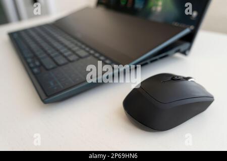 Laptop keyboard, black computer mouse. Working atmosphere on the table. Freelance. Business. Stock Photo