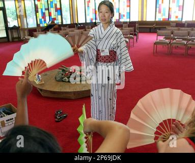 Dancer and anthropologist Kazuko Yamazaki demonstrates a fan dance