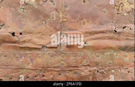 Steampunk Abstract background of old riveted copper sheet cladding. Grunge texture full frame Stock Photo