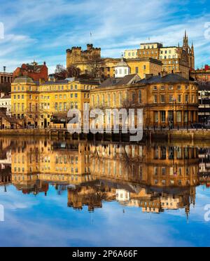 Early morning view in winter of Newcastle quayside reflected in the river tyne looking across from gateshead quayside Stock Photo