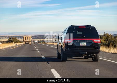 A picture of a black Lincoln Navigator EcoBoost driving in Arizona. Stock Photo