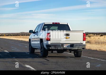 A picture of a white Chevrolet Silverado LT driving in Arizona. Stock Photo