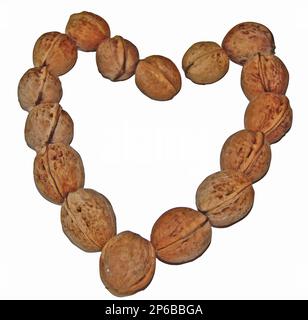the shape of a heart made of several walnuts Stock Photo