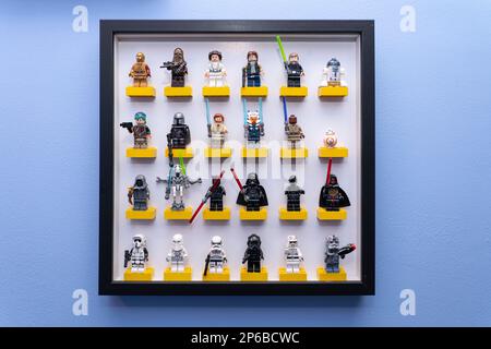 Rebel Alliance and Jedi together with the Galactic Empire and Sith Star Wars lego figures standing on lego bricks in a wall mounted picture frame Stock Photo
