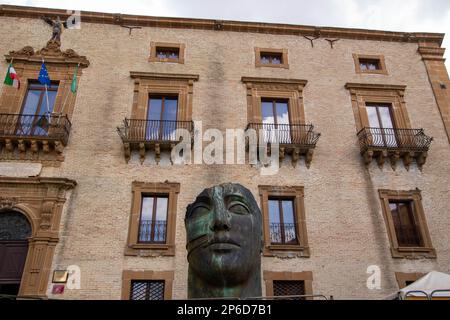 At PIazza Armerina, Italy , On 08-04-23, Tindaro, sculpture by Igor Mitoraji,  and the facade of the town hall Stock Photo