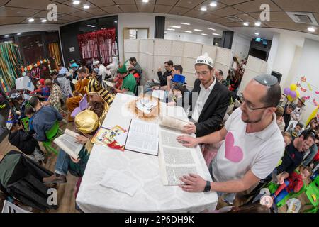 Harish, Israel. Reading of the scroll of Esther during the holiday of Purim In this holiday Jews traditionaly dress in costumes, read the scroll of Esther, a story about an anti-jewish failed plot in ancient Persia, and make a racket with clappers and other assorted noise-making devices whenever the name of Haman, the main antagonist, is mentioned. Stock Photo