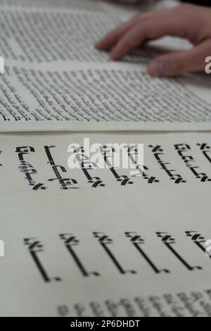 Israel. Closeup on the Scroll of Esther, read in synagogue during the holiday of Purim. In this section the names of the sons of Haman, the villain of the story, appears in large print, while the main story appears in small print. Stock Photo