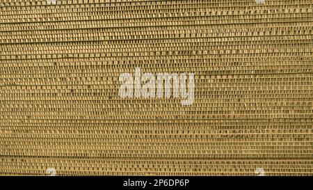 Background of a stack of thick corrugated cardboard. Side view of packing padding. Stock Photo