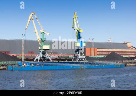 barge is loaded with coal at the port Stock Photo