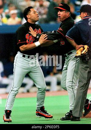 FILE - In this Oct. 12, 1997, file photo, Baltimore Orioles' Roberto Alomar  throws out Cleveland Indians' Bip Roberts to end the fourth inning of Game  4 of the American League Championship Series at Jacobs Field in Cleveland,  Ohio. Alomar and Bert