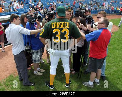 Former Major League Baseball player Jose Canseco takes a swing during the  Battle For Vegas Char …