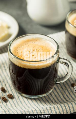 Warm Bulletproof Butter Coffee in a Glass Mug Stock Photo