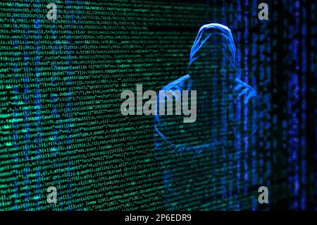 A computer hacker and lines of code Stock Photo