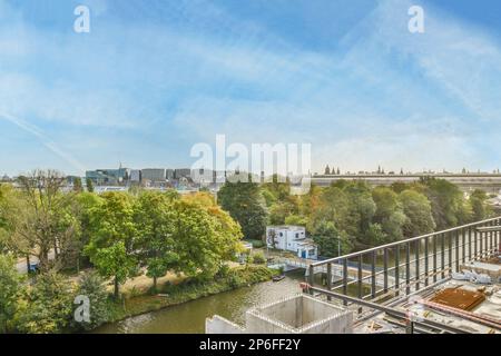 Amsterdam, Netherlands - 10 April, 2021: a city from the top of a building with trees and buildings in the background, taken on a sunny day Stock Photo