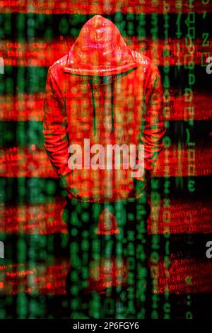 A hacker behind lines of computer code Stock Photo