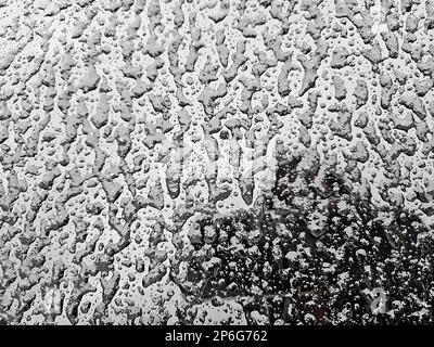 Ice overlay pattern on car windshield Stock Photo