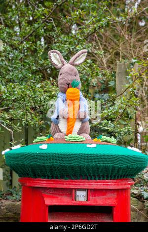 Peter Rabbit yarn bombing on a Royal Mail post box in the Derbyshire market town of Melbourne Derbyshire England Stock Photo