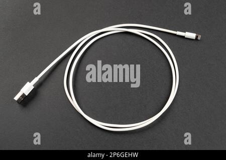 a white USB cable on a gray background Stock Photo