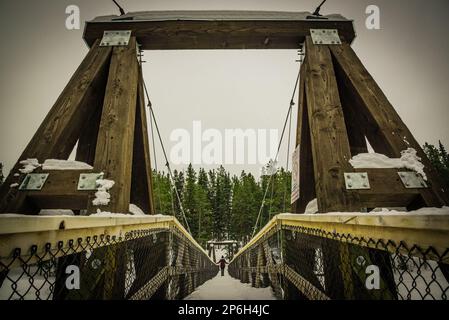 Suspension bridge outside of Whitehorse in northern Yukon Territory during winter season. Taken at Miles Canyon. Stock Photo